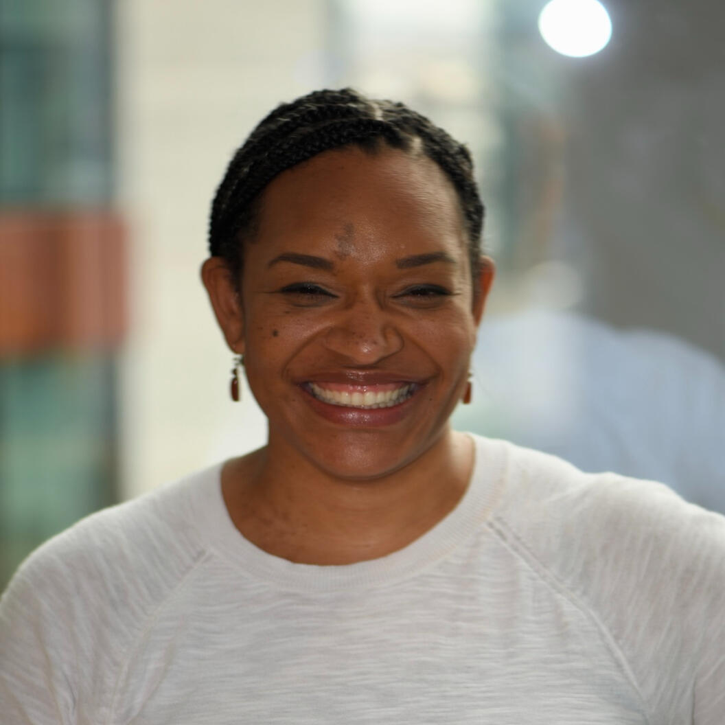 Photo of Denice Ochola of Akili Strategies smiling at the camera